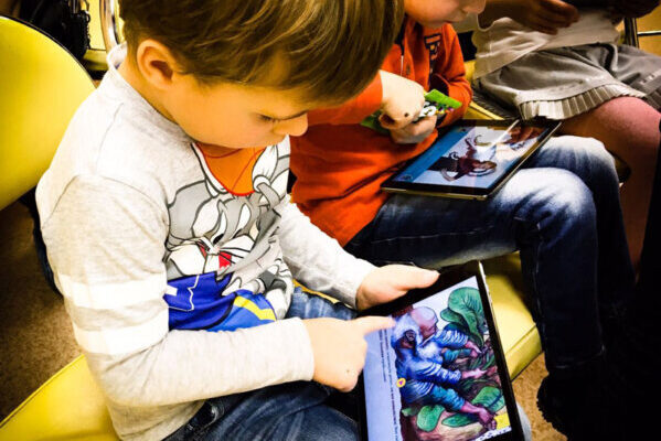A child reads a book on a tablet.