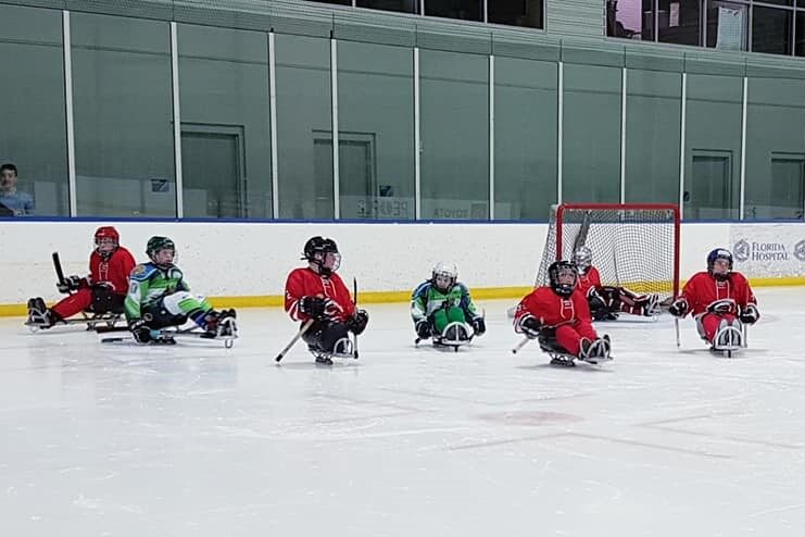 Hockey players with disabilities on the rink.