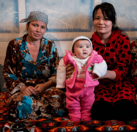 Two woman holding a small child