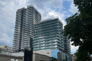 Two glass buildings rise above the smaller shops around them.