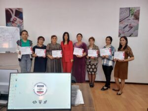 Eight women in professional outfits show off their certificates of completion.